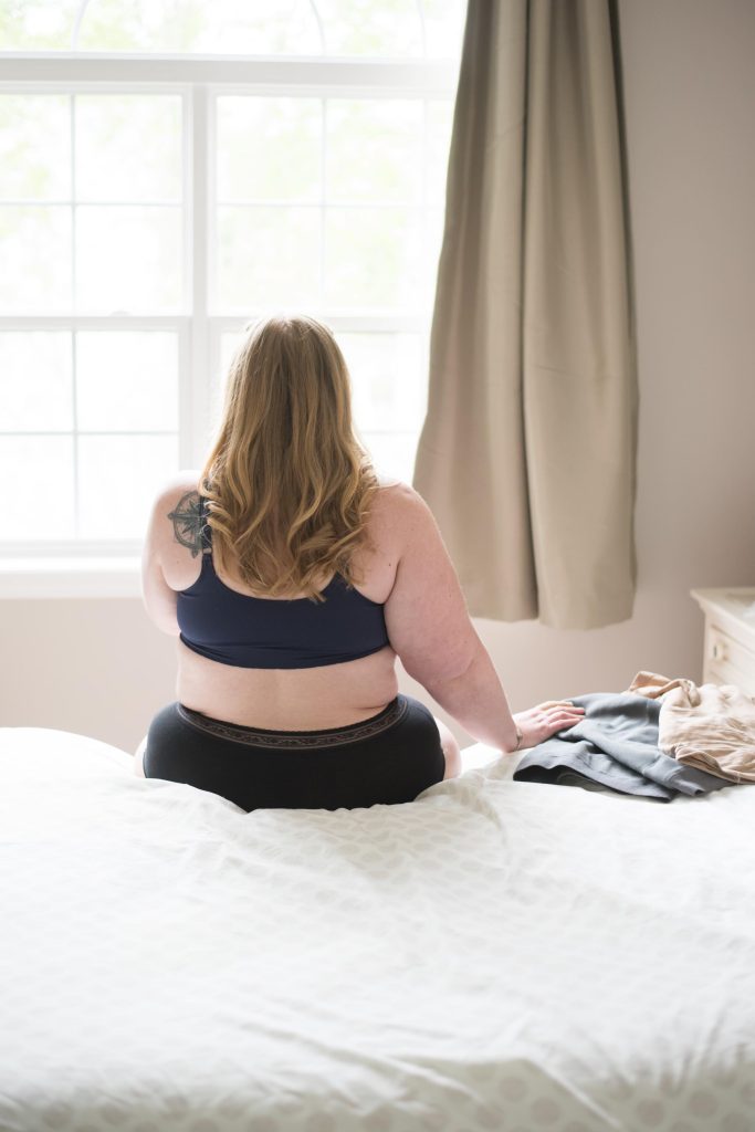 Crystal Ellingsen sitting on bed with compression